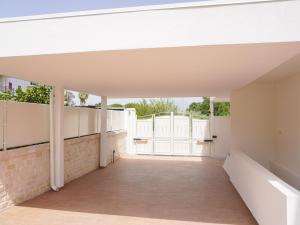 an empty hallway of a house with a white fence at La Martina Guesthouse in Angri
