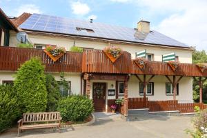 a house with solar panels on the roof at Ferienhotel Zwotatal in Klingenthal
