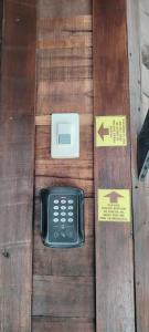 a remote control sitting on top of a wooden table at VNJ Capsule 216 in Hoi An