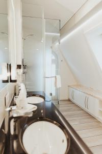 a bathroom with two sinks and a mirror at Villa Vivaldi in Kühlungsborn +30 photos