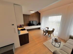a living room with a couch and a table at Elite Gerlach Mezonet in Svätý Jur