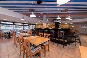 a restaurant with tables and chairs and a bar at Hotel Arena Liberec in Liberec