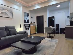 a living room with a couch and a table at Smart Cloud Apartment in Nairobi