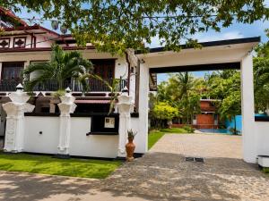an entrance to a house with a garage at Glory Rajarata Lakeside Resort in Anuradhapura