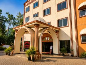 a building with an archway in front of a building at SRS Jade Empire in Kammasandra