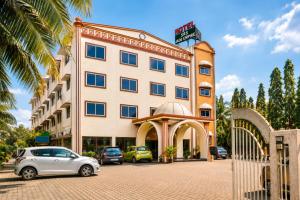 a building with cars parked in front of it at SRS Jade Empire in Kammasandra +15 photos