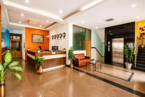 an office lobby with a reception desk and plants at SRS Jade Empire in Kammasandra