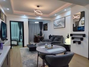 a living room with a couch and a table at Smart Cloud Apartment in Nairobi
