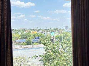 a view of a city from a window at JB Residency By Rio Grande in Tiruchirappalli