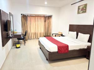a hotel room with a bed and a television at JB Residency By Rio Grande in Tiruchirappalli +50 photos