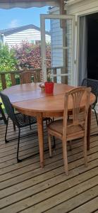a wooden table and chairs on a deck at Far west location in Vironchaux