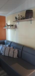 a blue couch with two pillows on it in a room at Far west location in Vironchaux