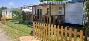 a wooden fence in front of a house at Far west location in Vironchaux