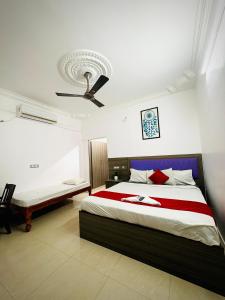a bedroom with a bed and a ceiling fan at Serenity beach side in Pondicherry