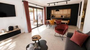 a living room with a couch and a table at Villas Vallée d'ASCO in Moltifao