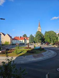a winding road in a town with a clock tower at Apartament DARIS in Wałbrzych