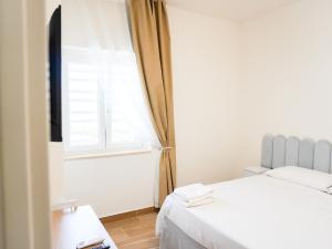 a bedroom with a bed and a window at La Martina Guesthouse in Angri