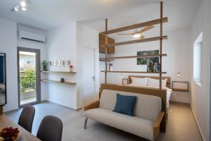a room with a bed and a chair and a table at Trigono Suites - Karat in Politika