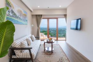 a living room with a couch and a table at Memories Hotel in Bảo Lộc