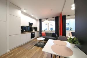 a living room with a couch and a table at A very cozy apartment with a large bed in Wrocław