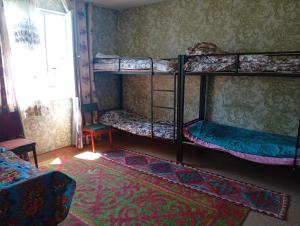 a room with two bunk beds and a window at Sam hostel in Kochkorka