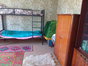 a room with two bunk beds and a cabinet at Sam hostel in Kochkorka