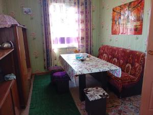a dining room with a table and a chair at Sam hostel in Kochkorka