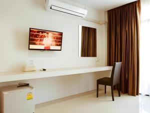 a room with a desk with a chair and a television at The Viewpoint Hotel in Ban Wat Tha Maprang +108 photos