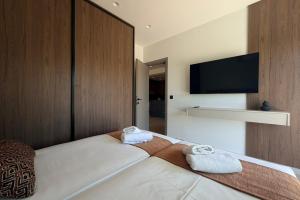 a bedroom with a bed with two towels on it at Mirena Exclusive Apartments in Afantou