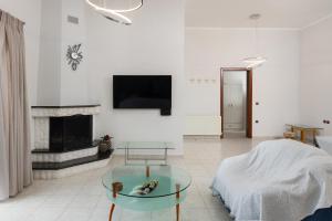 a living room with a glass table and a fireplace at Cielo Hillside Villa in Ialysos