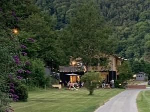 a house in the middle of a yard with trees at Camping Pier10 in Bourscheid