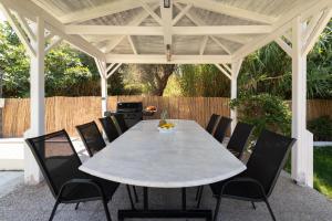 a white table and chairs under a pavilion at Cielo Hillside Villa in Ialysos