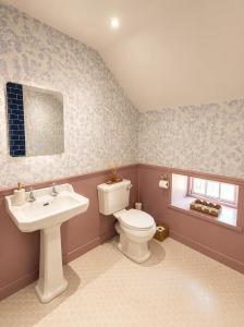 a bathroom with a toilet and a sink at Farrier's Rest in Belford