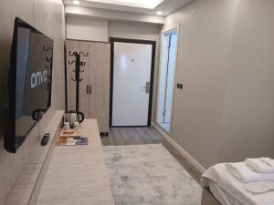 a room with a bed and a door to a room at Sunset Hill Hotel in Büyükçekmece