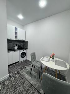 a white room with a table and a chair at APARTMENT Ultra central in Edineţ