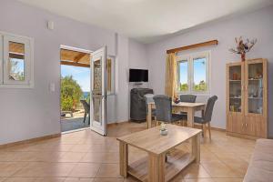 a living room with a table and a couch at Alkioni Sea View Apartment in Kato Zakros