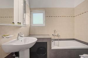 a bathroom with a sink and a bath tub at Alkioni Sea View Apartment in Kato Zakros +162 photos