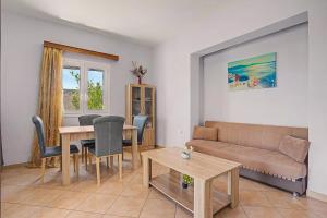 a living room with a couch and a table at Alkioni Sea View Apartment in Kato Zakros