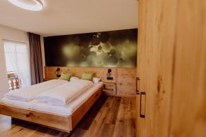 a bedroom with a large bed in a room at Schiebenrothenhof in Simonswald