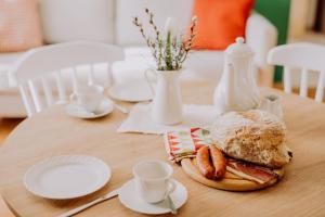 a wooden table with a plate of food on it at Schiebenrothenhof in Simonswald +9 photos