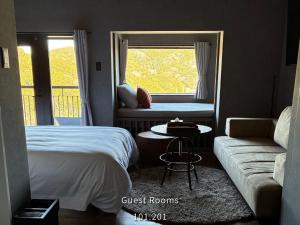 a room with two beds and a couch and a window at Retreat Hotel ENTO ISESHIMA in Funakoshi +115 photos