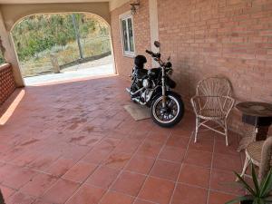 a motorcycle parked on a patio next to a brick wall at MADONIE Guest House in Petralia Soprana