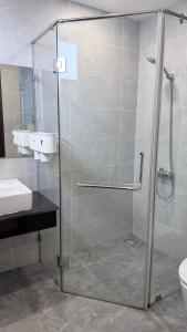 a shower with a glass door in a bathroom at Chung cư Csky View in Ga Phú Văn