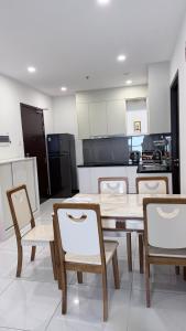 a kitchen with a wooden table and chairs in it at Chung cư Csky View in Ga Phú Văn
