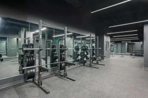 a gym with rows of dumbbells in a room at CozySuites at Sky Central in Cincinnati