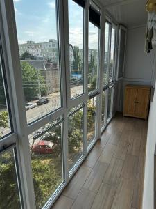 a room with windows with a view of a street at Elegant Apartment City Center in Tiraspol