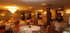 a dining room with white tables and chairs at Chaine ELDJAZAIR by HTT in Alger