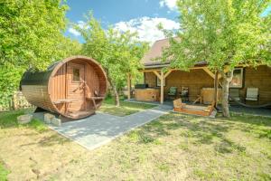 a large wooden hobbit house with a backyard at Domek Teremiski in Białowieża +5 photos