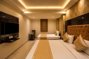 a hotel room with a bed and a flat screen tv at HOTEL ICONIC At Delhi International Airport in New Delhi