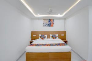 a bedroom with a bed in a room at FabHotel MV Luxury Rooms in Hyderabad